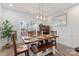 Dining room with stylish lighting fixture, wooden table and seating, and large window at 247 Timberland Loop, Mooresville, NC 28115