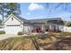 Well-kept single-story home featuring a two-car garage, classic front porch, and landscaped front yard at 247 Timberland Loop, Mooresville, NC 28115