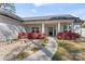 Inviting home exterior with a stone pathway, landscaped yard, and a charming covered porch at 247 Timberland Loop, Mooresville, NC 28115