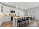 Modern kitchen with stainless steel appliances, granite counters, island with bar stools, and pendant lighting at 247 Timberland Loop, Mooresville, NC 28115