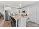 Modern kitchen with white cabinets, stainless appliances, island with barstool seating, and a pantry at 247 Timberland Loop, Mooresville, NC 28115