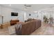 Inviting living room with a plush brown sectional sofa, modern decor, and wood-style flooring at 247 Timberland Loop, Mooresville, NC 28115