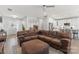 Open concept living room featuring a large brown sectional sofa, leading into the dining room and kitchen at 247 Timberland Loop, Mooresville, NC 28115