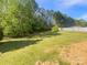 Well-maintained backyard with lush grass and a white fence in the distance at 249 Arrowood Ave, Lancaster, SC 29720