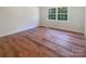 Bright bedroom featuring wood-look floors and a window for natural light at 249 Arrowood Ave, Lancaster, SC 29720