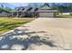 Beautiful brick home with manicured lawn, large driveway, and attached garage at 249 Arrowood Ave, Lancaster, SC 29720