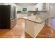 Well-lit kitchen with white cabinets, granite countertops, and stainless steel appliances at 249 Arrowood Ave, Lancaster, SC 29720