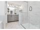 Elegant bathroom with glass shower, vanity, and modern lighting at 2520 Ensemble Ct, Charlotte, NC 28262