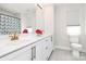 Bright bathroom with double sinks, modern fixtures, and a shower with a patterned curtain at 2520 Ensemble Ct, Charlotte, NC 28262