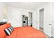 Bright bedroom with multiple doors, a cozy bed with patterned pillows, and ample natural light at 2520 Ensemble Ct, Charlotte, NC 28262