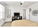 Cozy bedroom featuring a ceiling fan, television, and large window offering plenty of natural light at 2520 Ensemble Ct, Charlotte, NC 28262