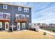 Back of a gray two-story home with balconies overlooking a grassy yard and neighboring houses at 2520 Ensemble Ct, Charlotte, NC 28262