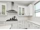 Modern kitchen with white cabinets, stainless steel hood, and subway tile backsplash at 2520 Ensemble Ct, Charlotte, NC 28262