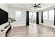 Sunlit living room featuring hardwood floors, sliding glass doors to a balcony, and a modern ceiling fan at 2520 Ensemble Ct, Charlotte, NC 28262