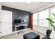 Stylish living room featuring a modern desk, chair, and sofa with large windows for natural light at 2520 Ensemble Ct, Charlotte, NC 28262