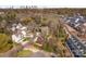 Aerial view of neighborhood showcasing the homes, mature trees, and skyline in the distance at 2558 Deacon Ave, Charlotte, NC 28204