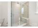 Modern bathroom featuring a glass-enclosed shower with a built-in bench and a handheld sprayer at 2558 Deacon Ave, Charlotte, NC 28204