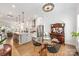 Open dining area is connected to the kitchen with modern chairs, hardwood floors, and modern fixtures at 2558 Deacon Ave, Charlotte, NC 28204