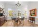 Bright dining area with large windows, modern chandelier, hardwood floors, and modern design elements at 2558 Deacon Ave, Charlotte, NC 28204
