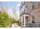 Charming brick townhome exterior with white columns, manicured landscaping, and a welcoming entrance at 2558 Deacon Ave, Charlotte, NC 28204