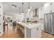 Beautiful kitchen with a center island, pendant lighting, stainless steel appliances and hardwood floors at 2558 Deacon Ave, Charlotte, NC 28204
