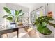 Bright sunroom with large windows, hardwood floors, and plants for a sunny and peaceful space at 2558 Deacon Ave, Charlotte, NC 28204