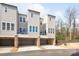 Modern townhomes with brick accents, garages, and landscaped front yards at 2558 Deacon Ave, Charlotte, NC 28204
