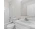 A white bathroom featuring a shower-tub combo, toilet, and a vanity with a sink at 2708 N Valley Ct, Charlotte, NC 28273