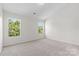 Bright bedroom featuring plush carpeting and two windows providing natural light at 2708 N Valley Ct, Charlotte, NC 28273