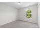Well-lit bedroom with a window view, plush carpeting, and a closet at 2708 N Valley Ct, Charlotte, NC 28273