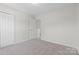 Inviting bedroom with neutral carpet, closet, and doorway leading to the hallway at 2708 N Valley Ct, Charlotte, NC 28273