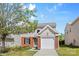 Charming two-story home with brick and vinyl siding and attached one car garage, nestled in a well-maintained yard at 2708 N Valley Ct, Charlotte, NC 28273