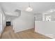 Inviting hallway with wood floors, a staircase, and open view to the living room featuring a fireplace at 2708 N Valley Ct, Charlotte, NC 28273