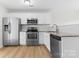 Modern kitchen with stainless steel appliances, granite countertops, white cabinets, and tile backsplash at 2708 N Valley Ct, Charlotte, NC 28273