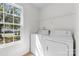 Bright laundry room featuring a side-by-side washer and dryer and a window view to the outside at 2708 N Valley Ct, Charlotte, NC 28273