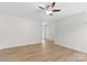 Spacious living room featuring wood flooring, a ceiling fan, and ample space for relaxation and entertainment at 2708 N Valley Ct, Charlotte, NC 28273