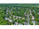 An aerial view of a suburban neighborhood with winding streets and lush green trees at 2710 Providence Spring Ln, Charlotte, NC 28270