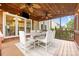 Covered back porch with ceiling fans, outdoor dining set, and string lights at 2710 Providence Spring Ln, Charlotte, NC 28270