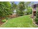 Expansive backyard with landscaped garden beds and a well-maintained lawn at 2710 Providence Spring Ln, Charlotte, NC 28270