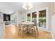 Inviting dining area featuring natural light, a chandelier, and views of the cozy living room at 2710 Providence Spring Ln, Charlotte, NC 28270