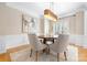 Inviting dining room featuring a modern light fixture, neutral paint, and stylish chairs surrounding a round table at 2710 Providence Spring Ln, Charlotte, NC 28270