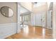 Grand foyer featuring hardwood floors, high ceilings, wainscoting, and elegant lighting at 2710 Providence Spring Ln, Charlotte, NC 28270