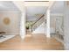 Open foyer boasts hardwood floors, staircase with black railings, and views into adjacent living spaces at 2710 Providence Spring Ln, Charlotte, NC 28270