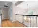 Hallway with hardwood floors, chandelier, and a window with plantation shutters at 2710 Providence Spring Ln, Charlotte, NC 28270