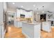 Spacious kitchen featuring an island, stainless steel appliances, white cabinets and views into the living room at 2710 Providence Spring Ln, Charlotte, NC 28270