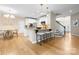 Open kitchen boasts a large island with seating, stainless appliances, and a seamless flow into the dining area at 2710 Providence Spring Ln, Charlotte, NC 28270