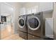 Convenient laundry room with modern washer and dryer units and ample storage space at 2710 Providence Spring Ln, Charlotte, NC 28270