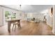 Open living room with hardwood floors, a sliding glass door to the backyard, and stylish seating at 2710 Providence Spring Ln, Charlotte, NC 28270