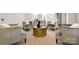 Cozy sitting area with four plush chairs, a round gold coffee table, and stylish decor at 2710 Providence Spring Ln, Charlotte, NC 28270