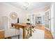 Bright office space featuring hardwood floors, ample natural light, and a view into the formal dining room at 2710 Providence Spring Ln, Charlotte, NC 28270